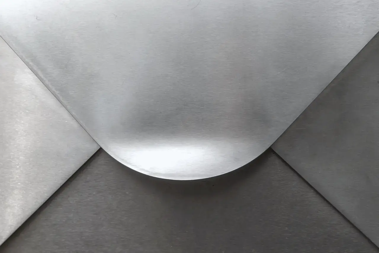 Brushed silver metallic panel with elegant curves