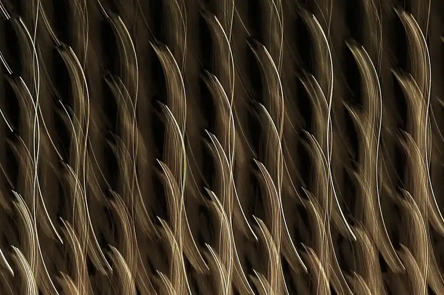 Water-ripple patterned metal surface in warm gold tone